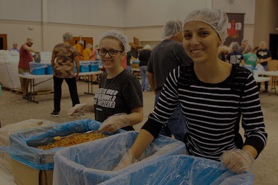 Volunteers packing meals at a Feed My Starving Children event